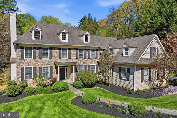 a aerial view of a house with yard and green space