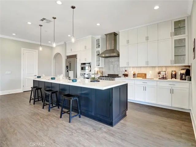 a kitchen with kitchen island granite countertop a sink a center island and cabinets