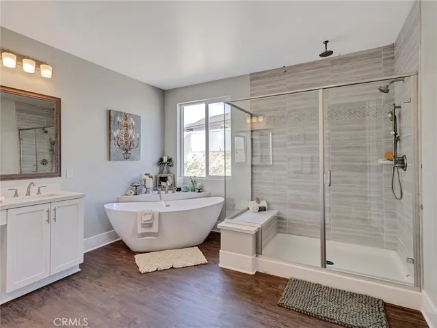 a bathroom with a double vanity sink a mirror and a shower