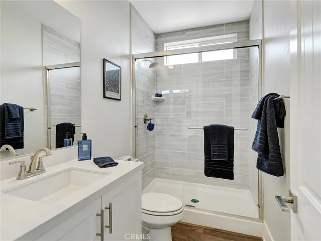 a bathroom with a sink a toilet and shower