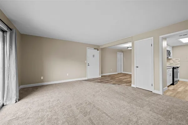 a view of an empty room and closet area