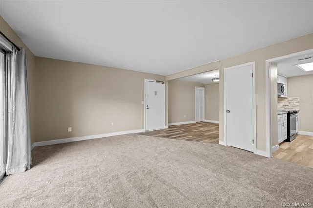 a view of an empty room and closet area