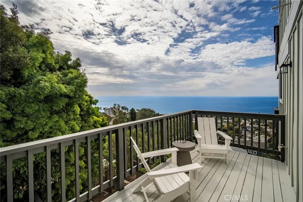 a balcony with wooden floor and fence