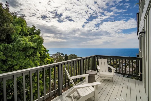 a balcony with wooden floor and fence