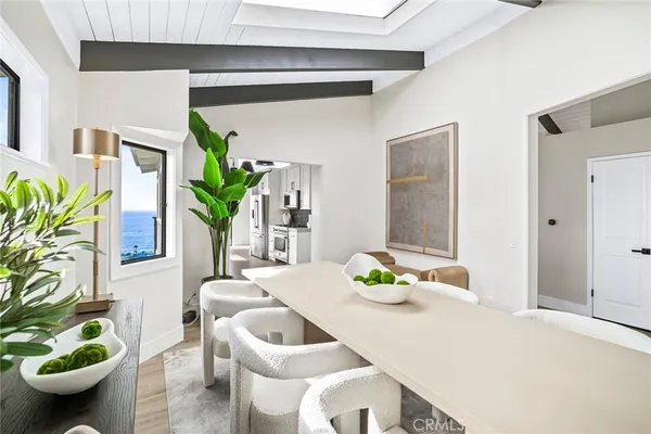 a dining room with furniture and a potted plant