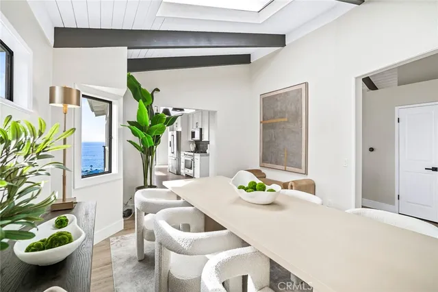 a dining room with furniture and a potted plant
