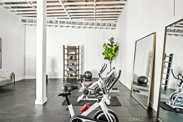a view of a hallway with wooden floor and closet