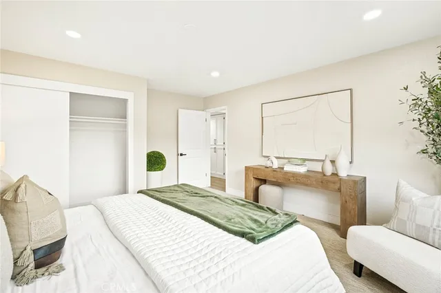 a bedroom with a large bed and a large window