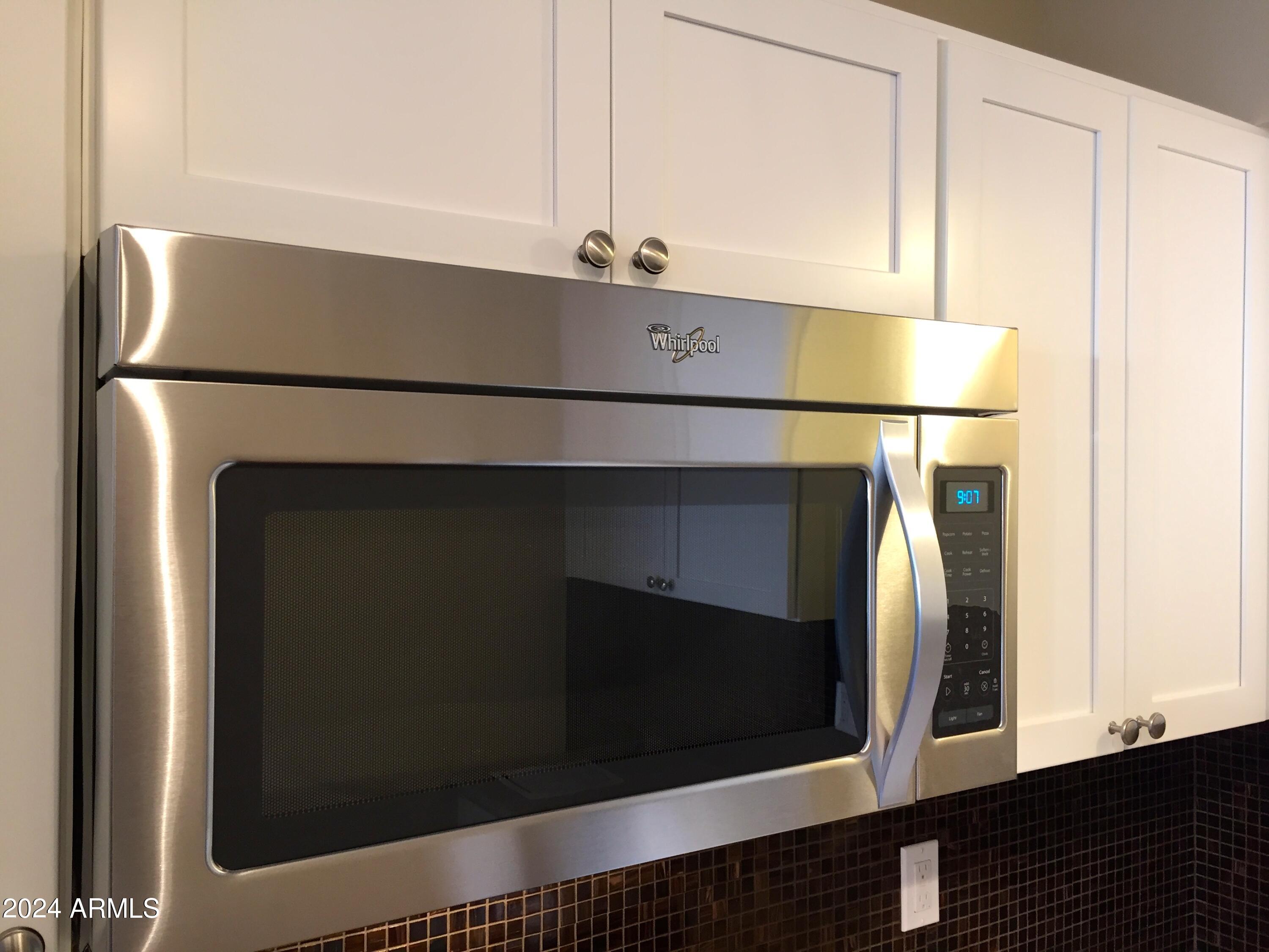1010 East Osborn Road, Unit D Phoenix, AZ 85014 - Photo 3 of 28 a kitchen with a refrigerator and a microwave