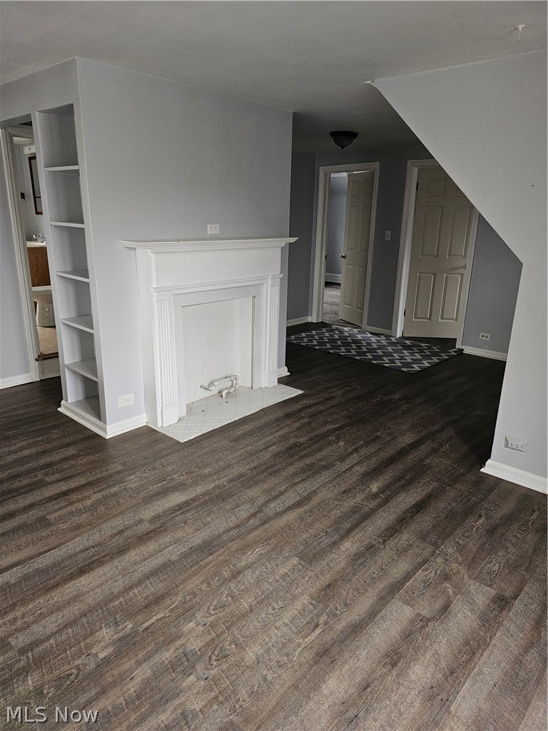 832 Hoover Road Cleveland, OH 44119 - Photo 7 of 10 Unfurnished living room featuring baseboards and dark wood-style floors