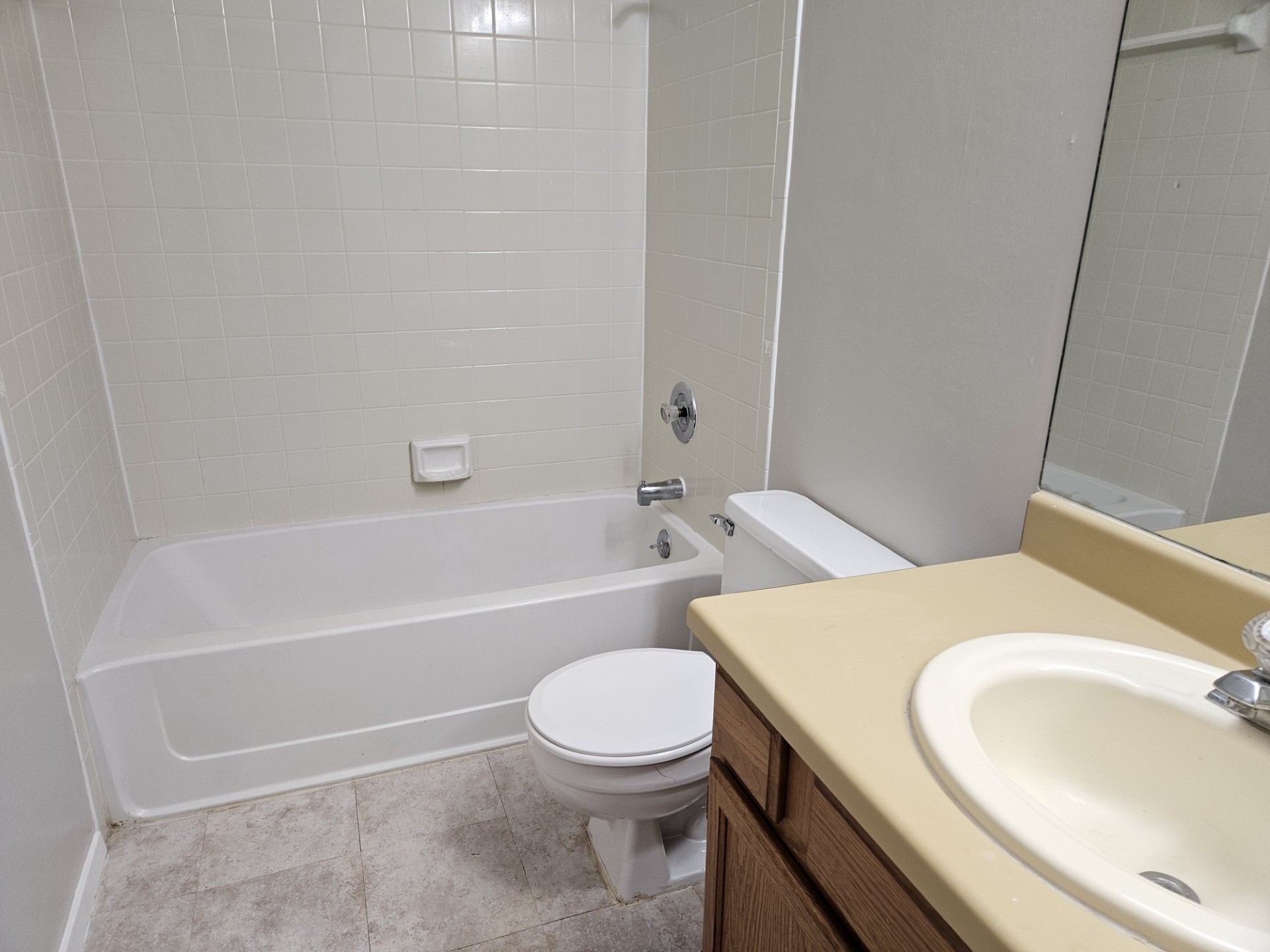 805 Lexington Road, Unit B Elgin, TX 78621 - Photo 9 of 11 A well-maintained full bathroom offers a classic tub and vanity setup.