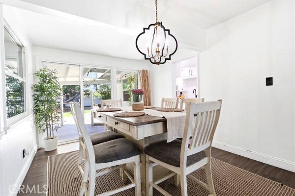 4866 Sunnyside Drive Riverside, CA 92506 - Photo 16 of 29 a dining room with furniture a chandelier and rug