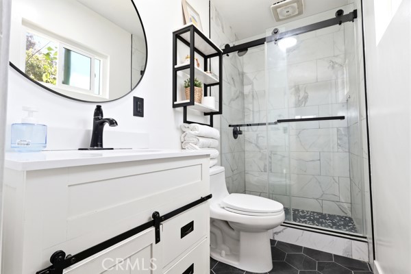 4866 Sunnyside Drive Riverside, CA 92506 - Photo 22 of 29 a bathroom with a toilet a sink and mirror