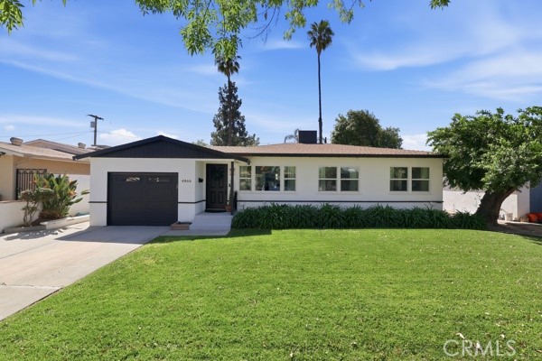 4866 Sunnyside Drive Riverside, CA 92506 - Photo 4 of 29 a front view of a house with a garden and yard