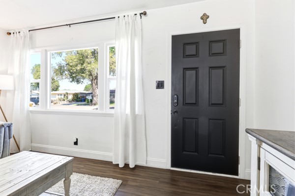 4866 Sunnyside Drive Riverside, CA 92506 - Photo 6 of 29 a view of a hallway with wooden floor and a window