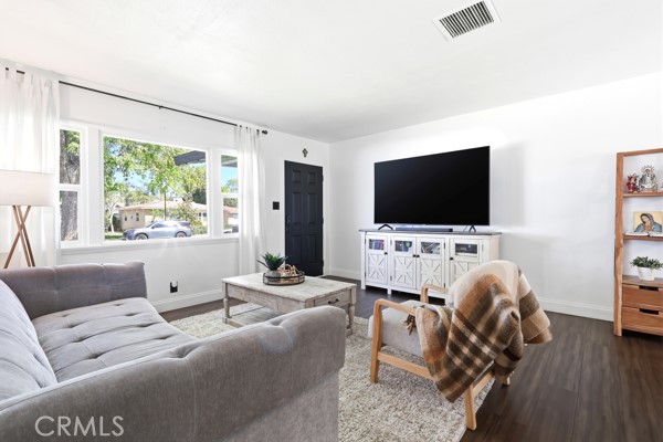 4866 Sunnyside Drive Riverside, CA 92506 - Photo 9 of 29 a living room with furniture and a flat screen tv