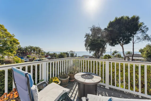 a view of a chair and table on the deck