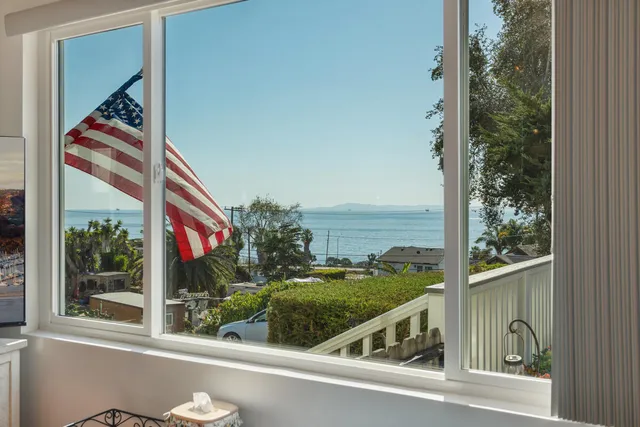 a view of a balcony and floor to ceiling windows and wooden floor
