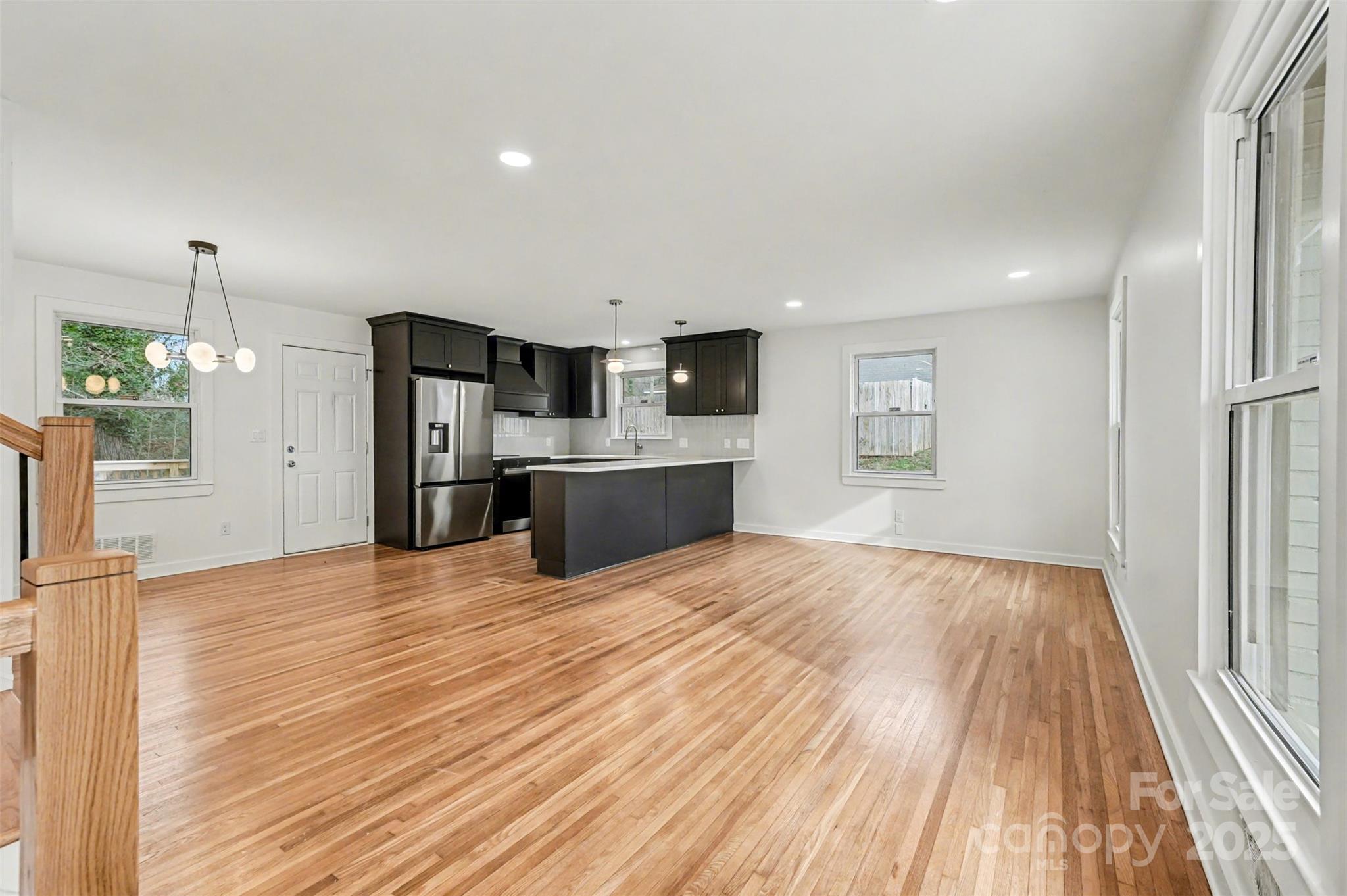 3417 Sudbury Road Charlotte, NC 28205 - Photo 3 of 18 a view of a kitchen with a sink and a refrigerator