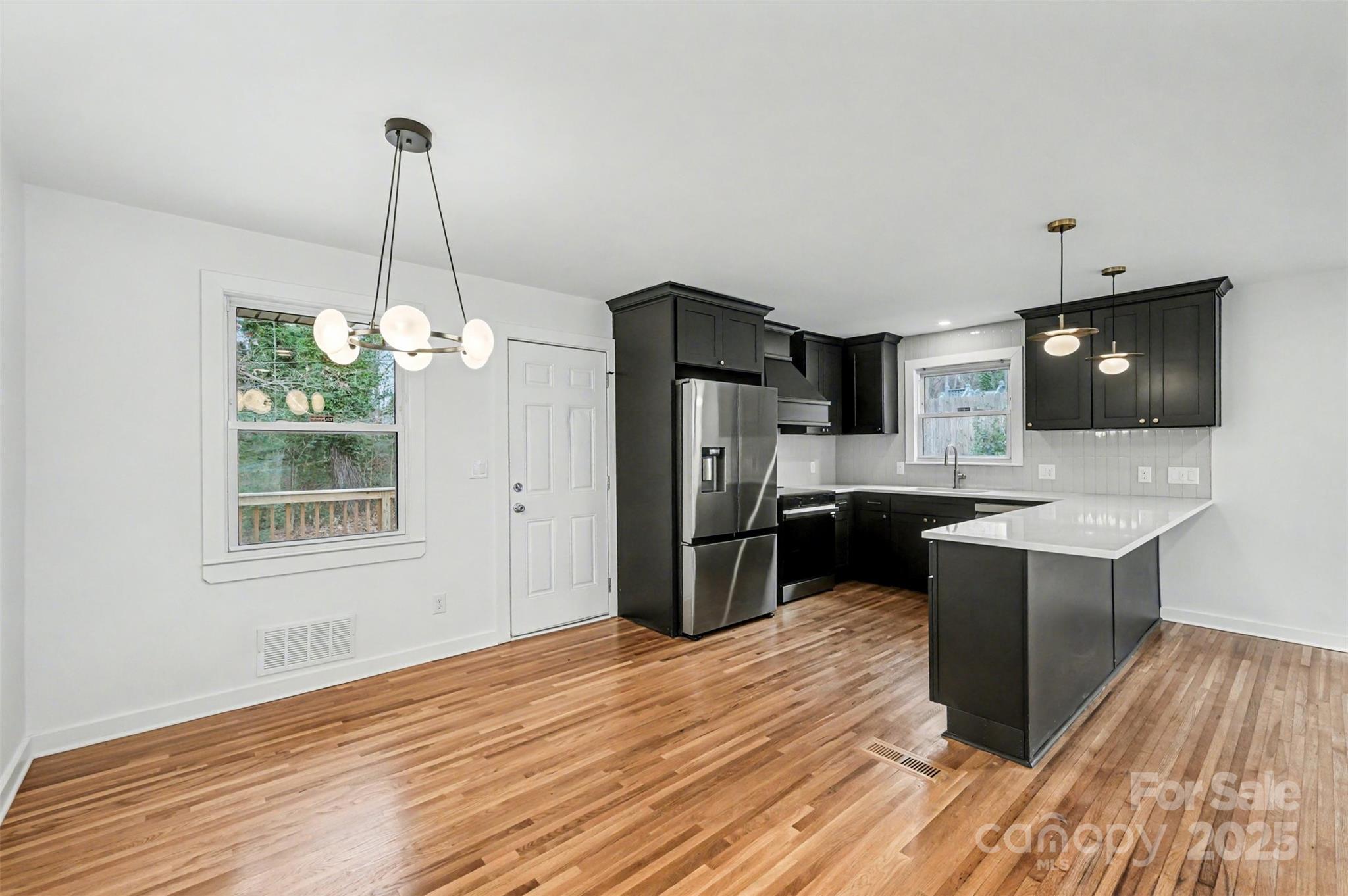 3417 Sudbury Road Charlotte, NC 28205 - Photo 5 of 18 a kitchen with kitchen island stainless steel appliances a sink stove and refrigerator