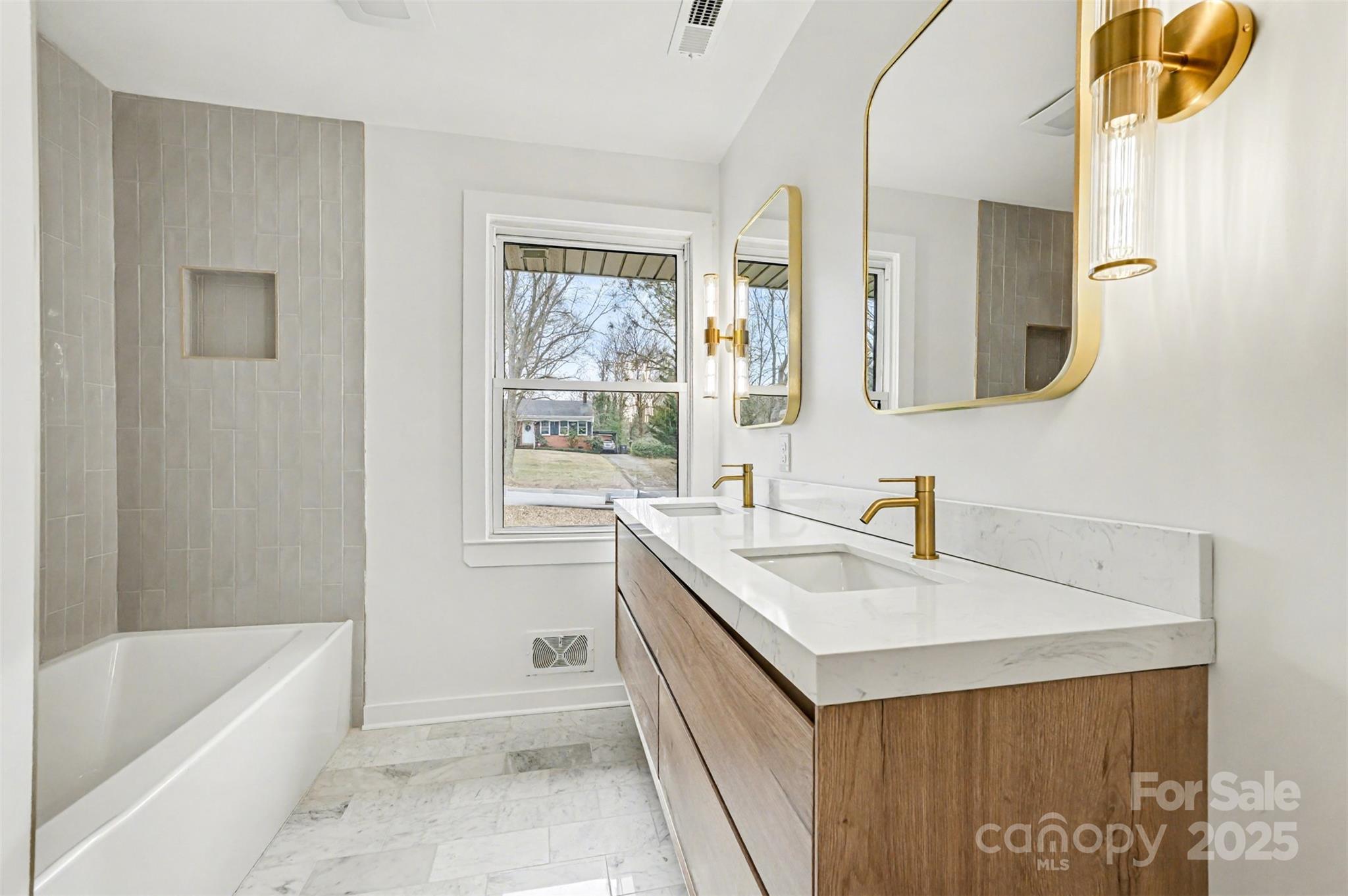 3417 Sudbury Road Charlotte, NC 28205 - Photo 8 of 18 a bathroom with a tub sink and mirror