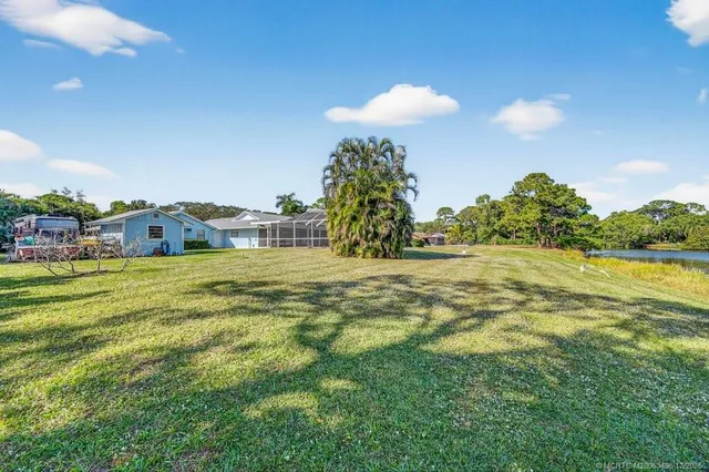 a view of backyard of house with green space