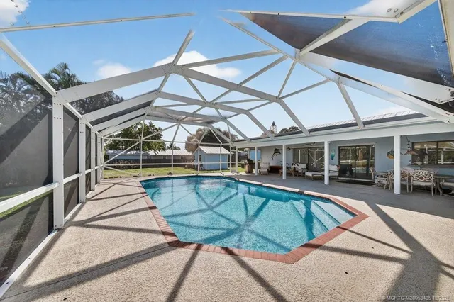 a bedroom with furniture and a large window