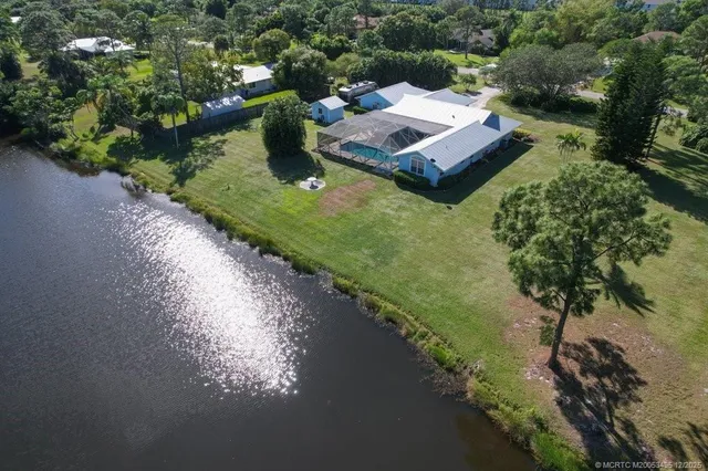 an aerial view of house with a yard and swimming pool