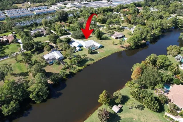 an aerial view of residential house with outdoor space and swimming pool
