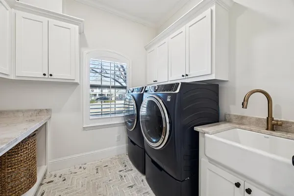a utility room with sink dryer and washer