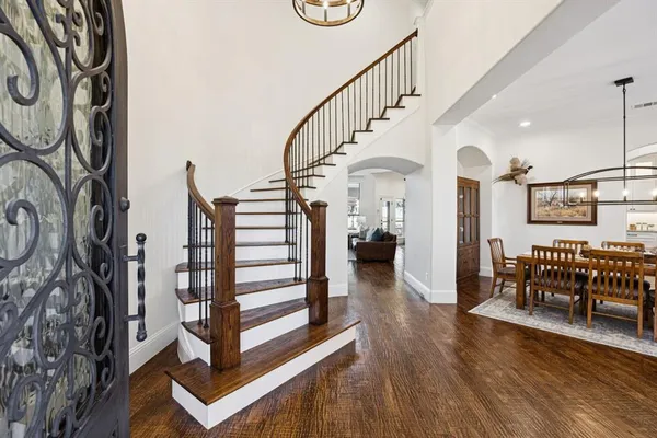 a view of entryway and hall with wooden floor