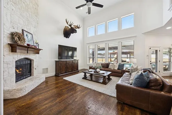 a living room with furniture a fireplace and a flat screen tv