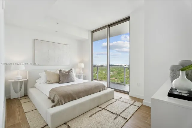 a bedroom with a large bed and a window