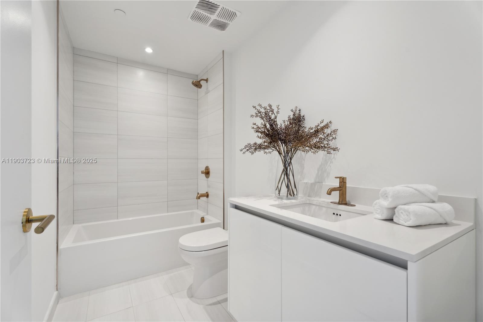 2678 Tigertail Avenue, Unit 1202 Miami, FL 33133 - Photo 15 of 20 a bathroom with a sink toilet and shower