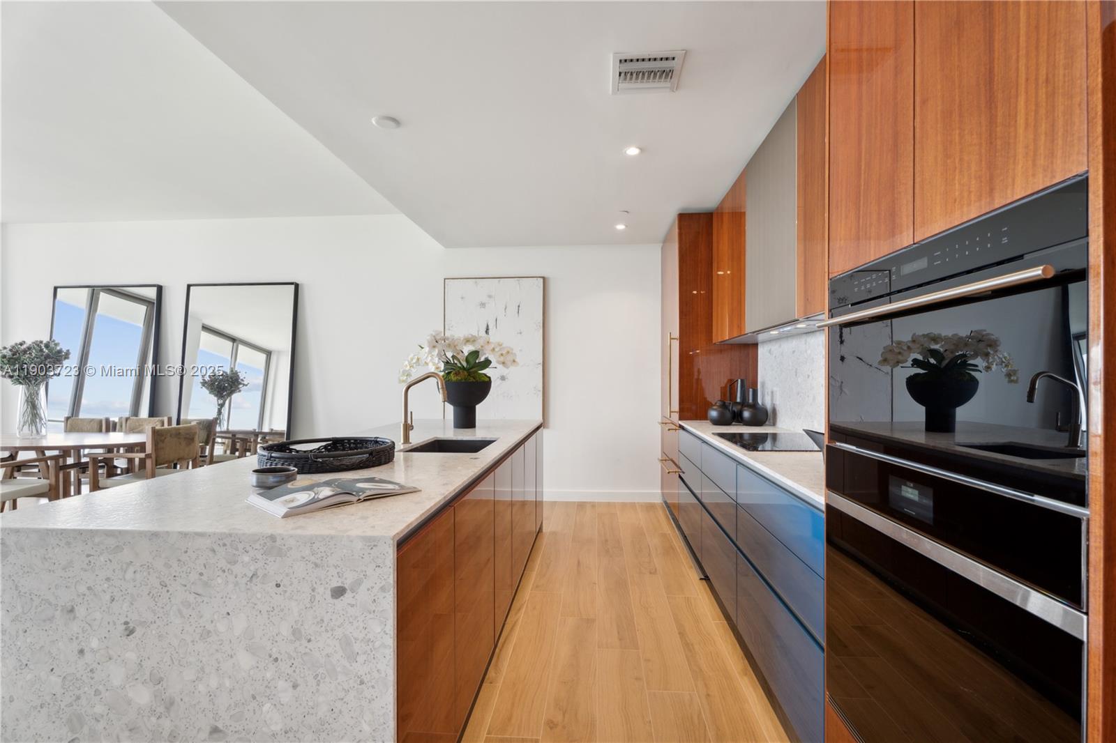 2678 Tigertail Avenue, Unit 1202 Miami, FL 33133 - Photo 6 of 20 a dining hall with stainless steel appliances granite countertop a stove and a sink