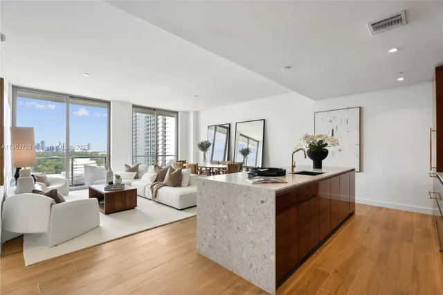 a view of living room with furniture and large windows