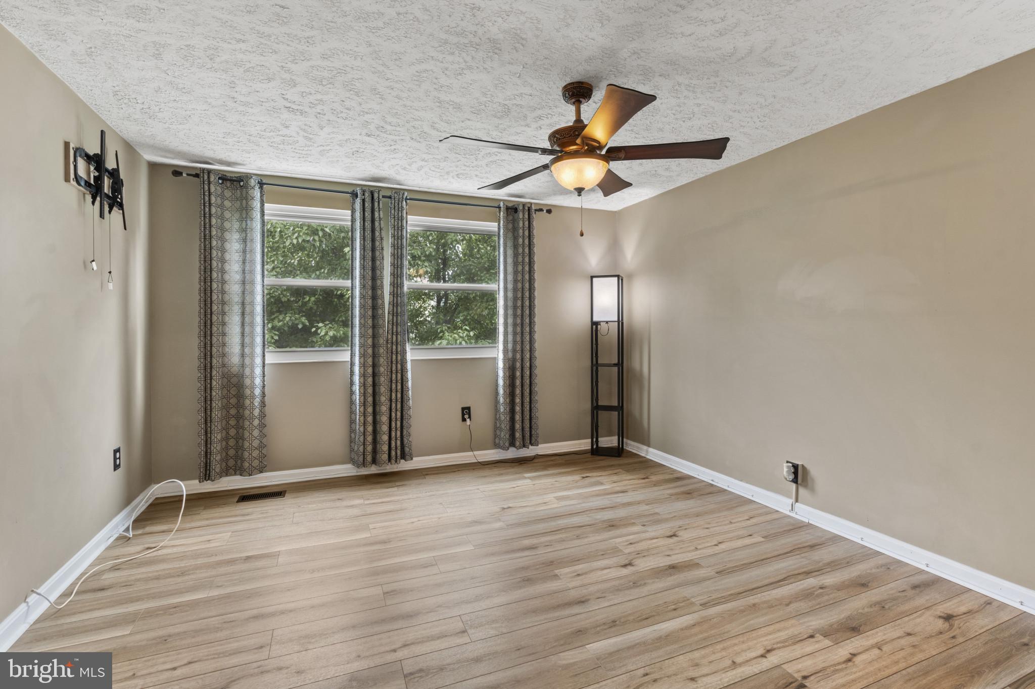 3210 Split Oak Court Abingdon, MD 21009 - Photo 12 of 17 a view of an empty room with wooden floor and a window