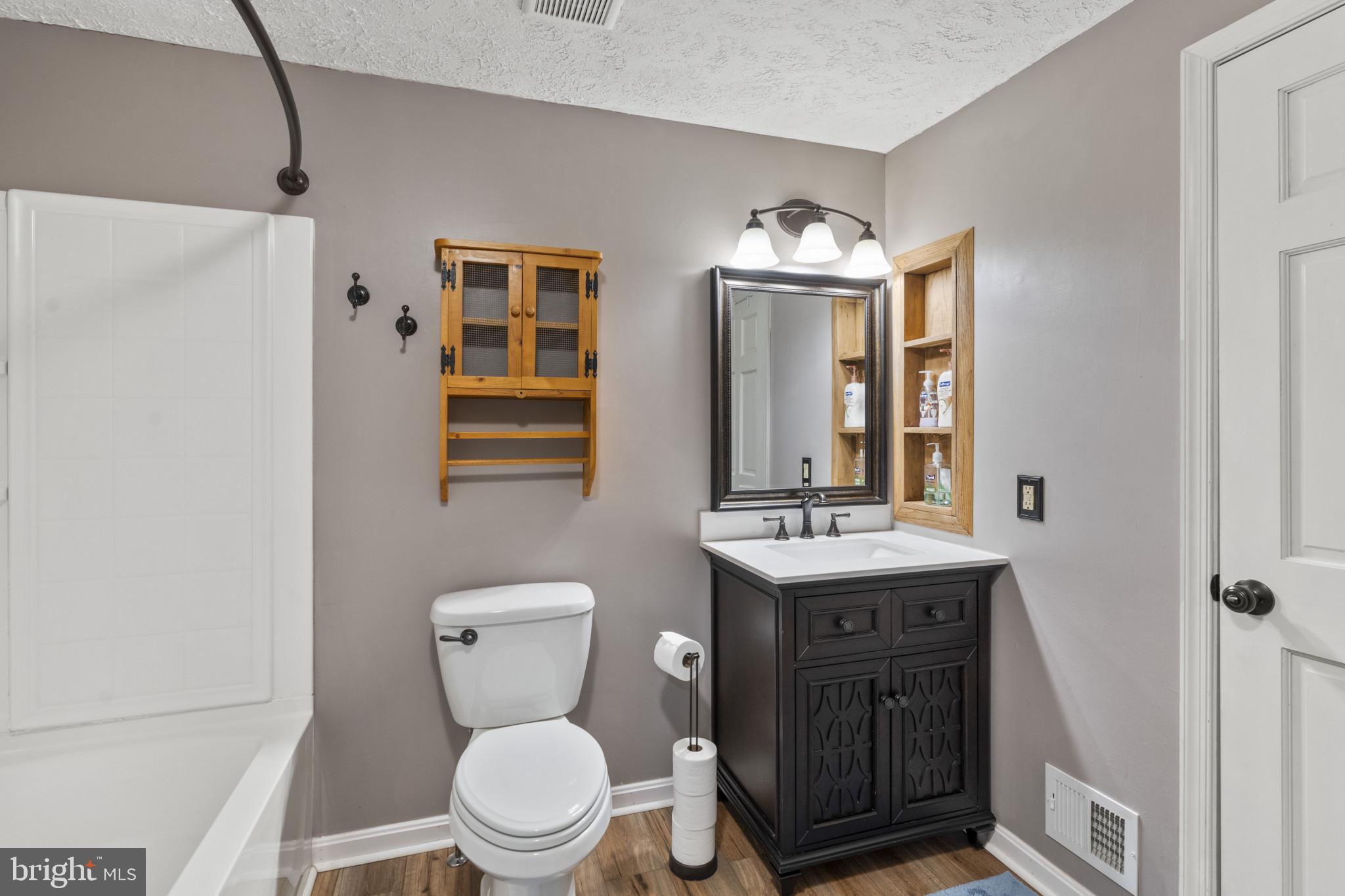 3210 Split Oak Court Abingdon, MD 21009 - Photo 14 of 17 a bathroom with a toilet a sink and mirror
