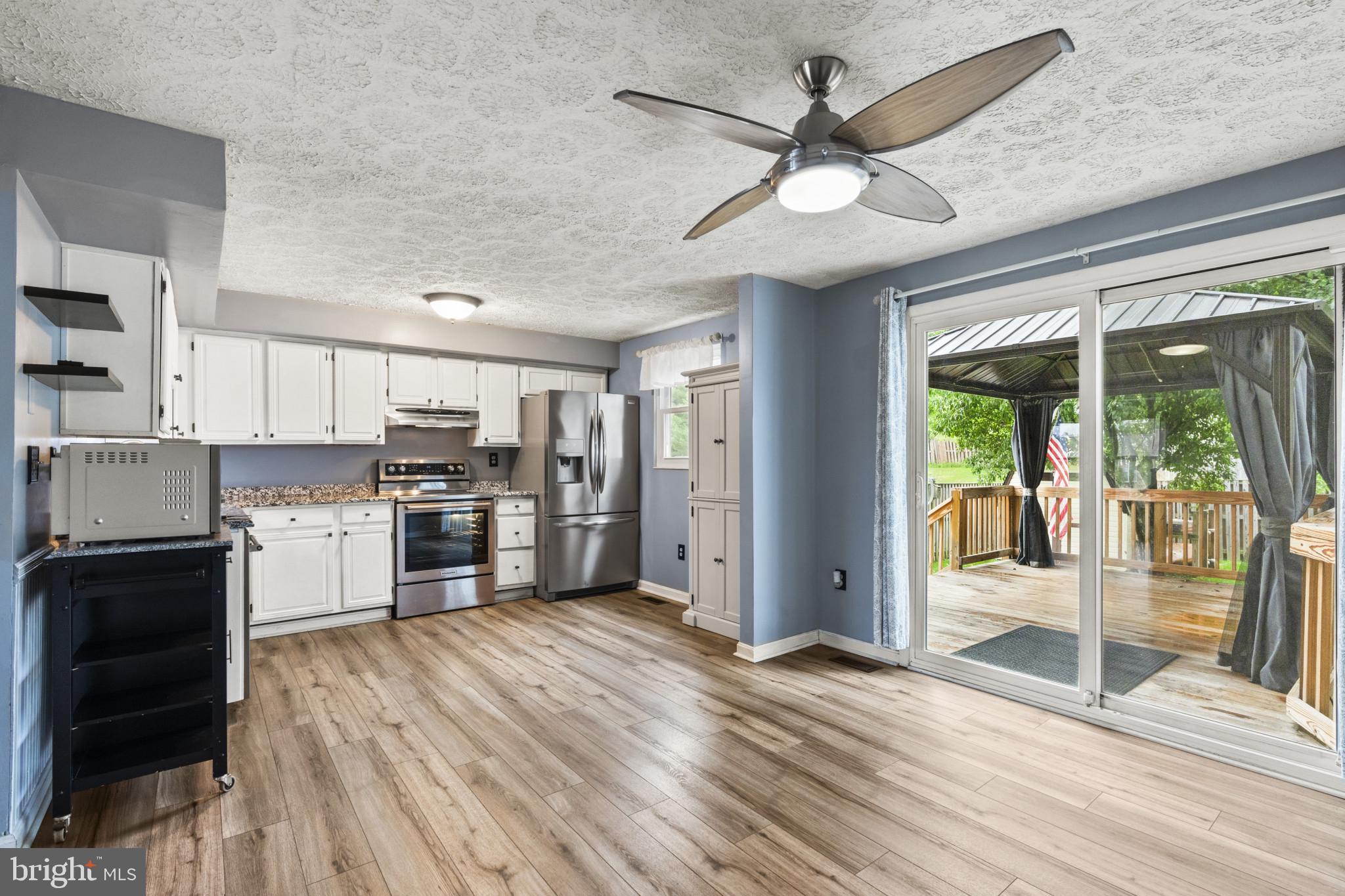3210 Split Oak Court Abingdon, MD 21009 - Photo 5 of 17 a kitchen with stainless steel appliances a stove top oven and a refrigerator