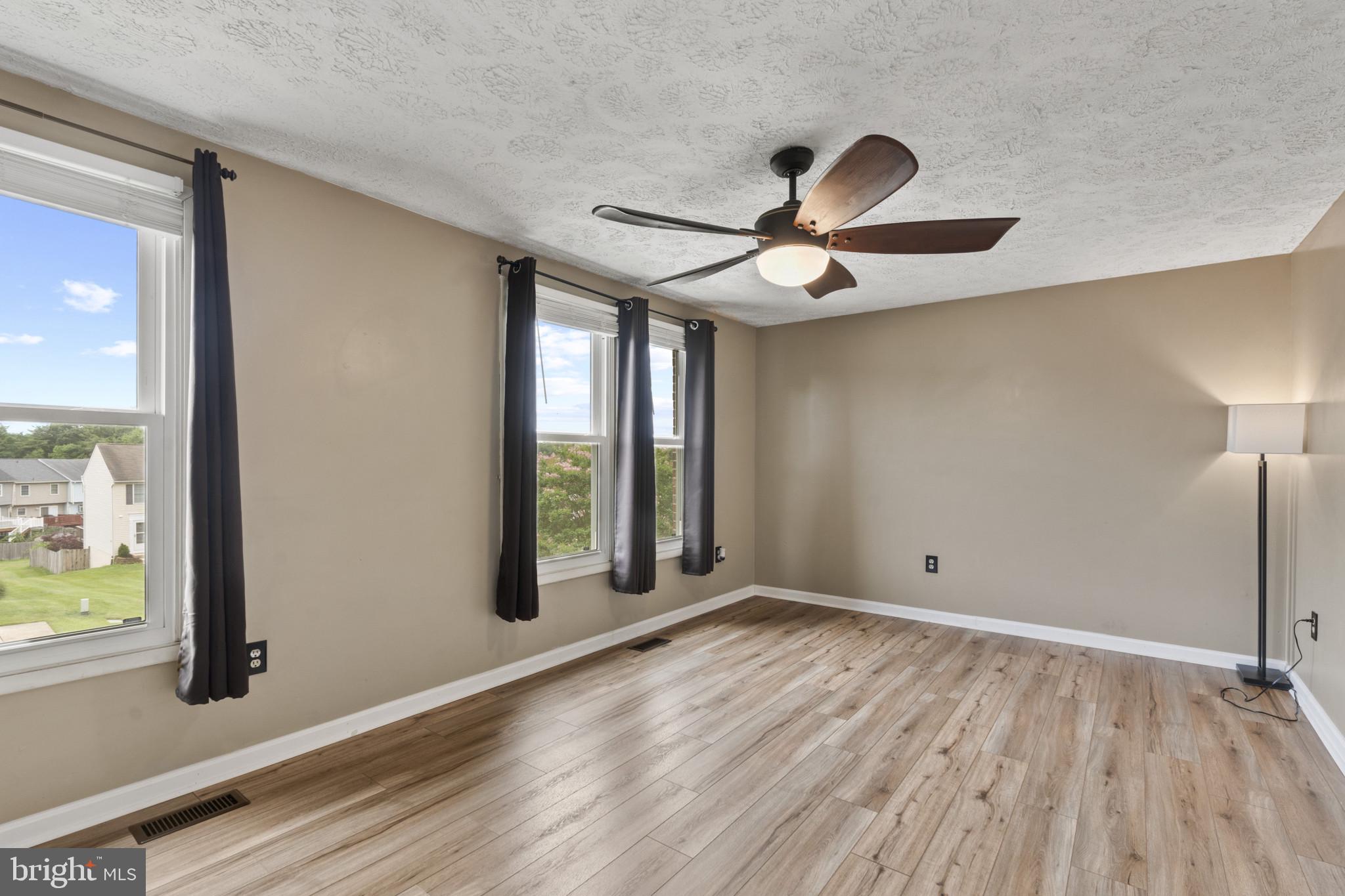 3210 Split Oak Court Abingdon, MD 21009 - Photo 9 of 17 a view of an empty room and window and wooden floor