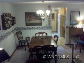 37 George Circle Maggie Valley, NC 28751 - Photo 2 of 15 a view of a dining room with furniture and chandelier