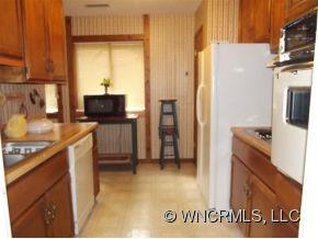 37 George Circle Maggie Valley, NC 28751 - Photo 11 of 15 a kitchen with a refrigerator and a stove