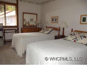 37 George Circle Maggie Valley, NC 28751 - Photo 14 of 15 a bedroom with a bed and a large window