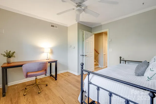 a bedroom with a bed and a desk