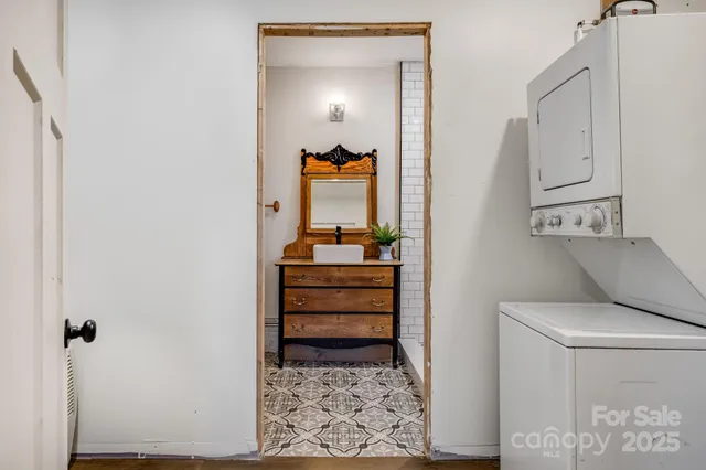 a view of a bedroom with baby crib and cabinet