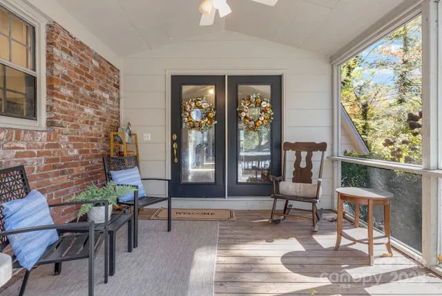 a living room with furniture and a floor to ceiling window