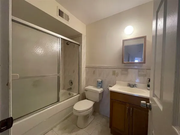 a bathroom with a toilet a sink and shower