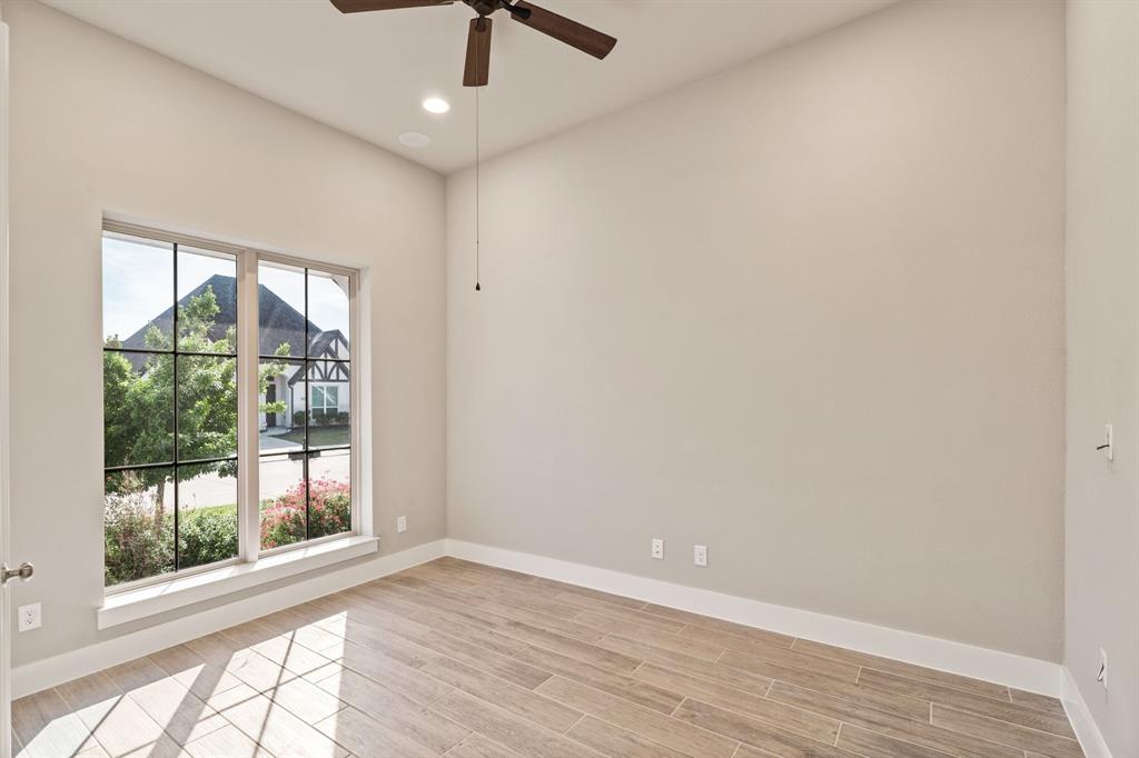 1314 Buttermere Street Forney, TX 75126 - Photo 15 of 32 an empty room with wooden floor fan and windows