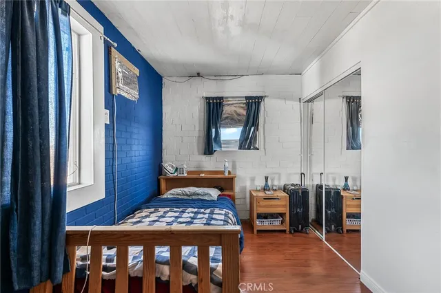 a bedroom with furniture and a mirror