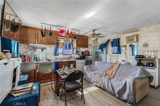 a living room with furniture and a kitchen
